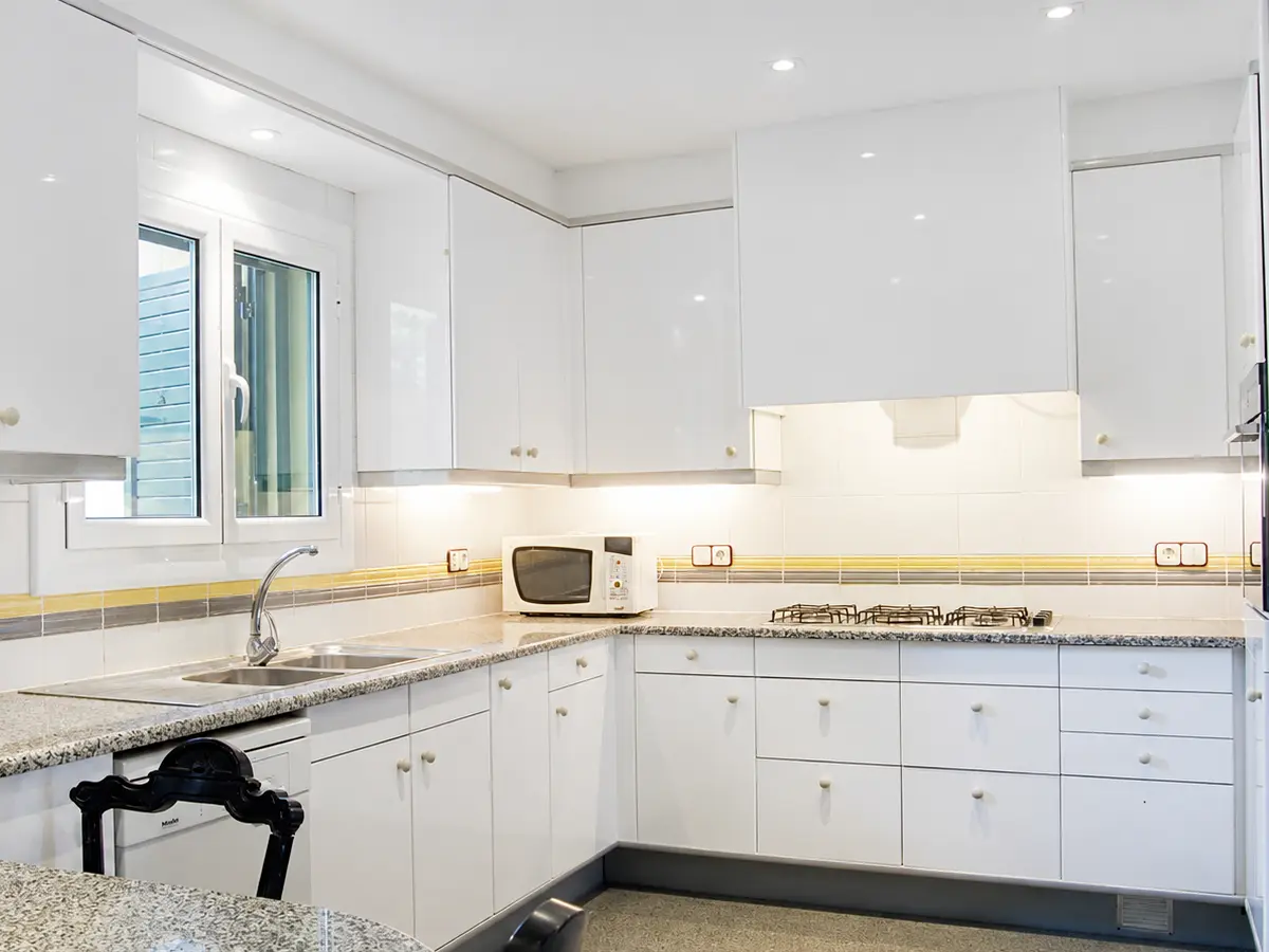 Large shared kitchen with two refrigerators and dining area for seven students